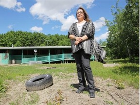 Alayna Many Guns stands in front of the flood affected home of her father-in-law on Siksika Nation, south of Gleichen, Alberta Thursday, June 5, 2014.