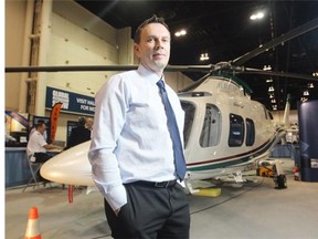 Albatros Aircraft vice-president Joe Viveiros poses with a $7-million executive helicopter at the Global Petroleum Show on Thursday. He said approval of the Northern Gateway pipeline will be good for his business.