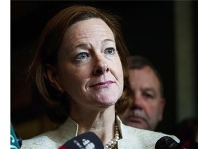 Alberta Premier Alison Redford meets with media following a meeting of the provincial PC Party executive in Calgary, Alta., Saturday, March 15, 2014. CBC News is reporting that Alberta's auditor general found "false passengers" were booked on some government flights so that then-premier Redford could fly alone. THE CANADIAN PRESS/Jeff McIntosh