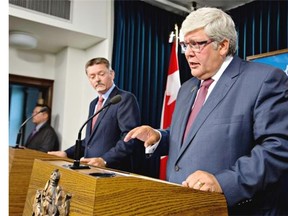 Alberta Premier Dave Hancock, right, and Doug Horner, President of Treasury Board and Minister of Finance, provide an update on the government’s response to recommendations in the Auditor General’s Special Duty Report on the Expenses of the Office of Premier Redford and Alberta’s Air Transportation Services Program, in Edmonton on Tuesday.