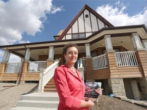 Alida Visbach, president and CEO of Heritage Park Historical Village, stands outside a replica of Nellie McClung’s home that will serve as an interpretive centre honouring the stories of women in Canadian history, including Alberta’s Famous 5. The centre will open at the park June 20.