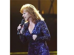 American country music singer, songwriter and actress, Reba McEntire, performs at the Saddledome on Sunday as the 2014 Calgary Stampeded comes to an end.