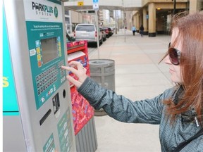 Andrea Rudoski pays for parking in the 700 block of 8th avenue S.W. — an area in downtown that has seen the highest number of parking tickets.