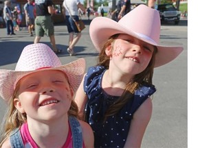 Anika Marshall, 5, and Zoe Zimmerman, 4, dressed up in their pink cowboy hats as they attended the Calgary Stampede Sneak-A-Peek on Thursday night.
