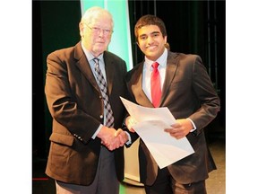 Arjun Nair receives the young innovator designation at a Canada-wide science fair from Dick Wilson in Waterloo, Ont. this week. (Supplied/Calgary Herald)