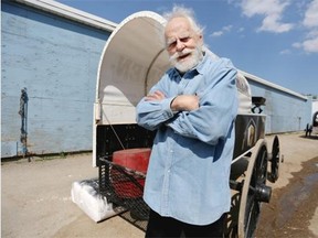 Artist Oleg Stavrowsky, 83, poses for a photo near the chuckwagons during the Calgary Stampede on July 10. Stavrowsky created the 2015 poster of chuckwagons.