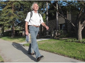 Bernie Howgate, on a sidewalk in southwest Calgary on Tuesday, has travelled with world selling his books about his world travels.