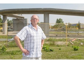 Brentwood resident Robert Mercer stands in front of an under-construction pedestrian bridge on Shaganappi Trail in Calgary on Tuesday.