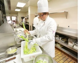 Bridgette Biddell cuts vegetables during her class at SAIT Polytechnic as part of a pilot project to train four students with autism spectrum disorder.