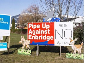 Competing campaign signs share a lawn in Kitimat, B.C. on April 12, 2014.