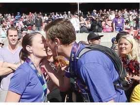 Calgary, Alberta; JUNE 1, 2014 - Amy Mayes is kissed after Jeff Neilson proposes after running the Calgary Scotiabank Marathon on June 1, 2014. (Christina Ryan/Calgary Herald)