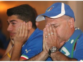 Renato Angelozzi, right, and his nephew Joseph Izzo react to Italy missing a goal against Uruguay while watching the World Cup soccer game at the Italian Club on Tuesday.