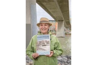 Calgary, Alberta; June 24, 2014 -- Sally Truss poses with a hand-printed, hand-bound book of art, stories and poems about the 2013 flood written by the city's homeless, called Flood Stories: Creative Flotsam on the Edge of High Water, released by This is My City Art Society in Calgary, on June 24, 2014. (Photo by Crystal Schick/Calgary Herald) 
 For , story by Jason van Rassel. Trax # 00056647A