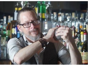 Nathan Head, co-owner of Milk Tiger, shakes up a Champs Elysees drink at the 4th Street SW lounge Thursday August 14, 2014.