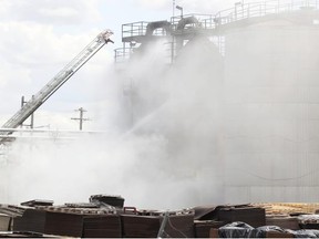 Calgary fire crews battle a blaze at IKO Industries on Tuesday. The roofing plant was the site of a fire in mid-March.