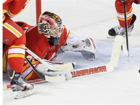 Calgary Flames goalie Joni Ortio stretches for the puck against the New York Islanders during a game last March.