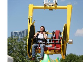 Calgary Herald reporter Reid Southwick rides the Skyscraper at the Calgary Stampede.