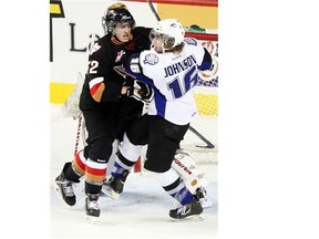 Calgary Hitmen defenceman Travis Sanheim pushes Swift Current Bronco Andrew Johnson out of the way during a meeting last December. The Hitmen will be battling for one of the top three spots in their division next season — guaranteed playoff positions.