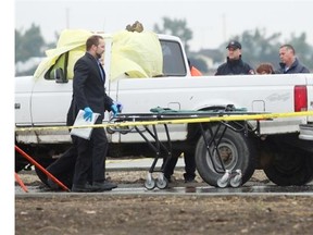 Calgary Police investigate the scene where a body was found in a truck on 17th Avenue and 84th Street S.E. on Wednesday.