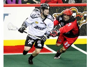 Calgary Roughnecks defenceman Andrew McBride provided some pressure as he checked Edmonton Rush forward Robert Church during Game 1 of the NLL West final series against Edmonton last week at the Saddledome.