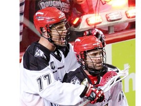 Calgary Roughnecks Jeff Shattler, left, and Shawn Evans celebrates a goal on the Rochester Knighthawks during Game 1 of the National Lacrosse League’s Champions Cup final at the Scotiabank Saddledome in Calgary on Saturday night. Calgary won 10-7.