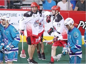 Calgary Roughnecks Jeff Shattler, middle, celebrates his goal on the Rochester Knighthawks during the National Lacrosse League’s Champions Cup final at the Scotiabank Saddledome.