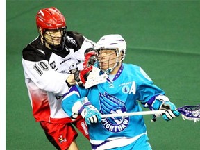 Calgary Roughnecks transition Curtis Manning lays a check on Rochester Knighthawks forward Cody Jamieson during NLL action at the Scotiabank Saddledome in February. Jamieson wound up leading the league in scoring this season and presents a major challenge for Calgary’s defence in the Champions Cup final.