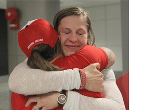 Calgary rugby player Maria Samson is met at the airport by friends Friday night after returning from the 2014 women’s rugby World Cup, where Canada finished second.