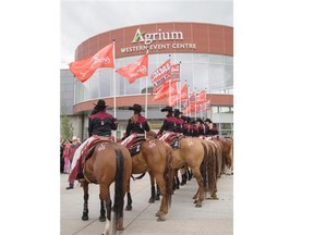 The Calgary Stampede show riders line the sidewalk for the official opening of the Agrium Western Event Centre at Stampede Park in Calgary on Saturday June 21, 2014.