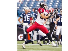 Calgary Stampeders' Anthony Parker catches a pass for first down yardage from quarterback Bo Levi Mitchell during the first half of their CFL game against the Toronto Argonauts in Toronto on Saturday July 12, 2014. THE CANADIAN PRESS/Fred Thornhill