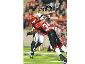 Calgary Stampeders defensive lineman Charleston Hughes tackles Hamilton Tiger Cats quarterback Dan LeFevour in a game last month. He also hit the Ticats pivot hard in last Saturday’s game, causing an interception.