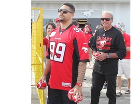 Calgary Stampeders defensive lineman Corey Mace, left, seen with head coach/GM John Hufnagel during last month’s Fan Fest, is the biggest addition to the front four this season as he returns from injury.