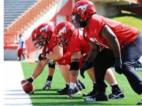 Calgary Stampeders offensive linemen line up during practice at McMahon Stadium on Tuesday.