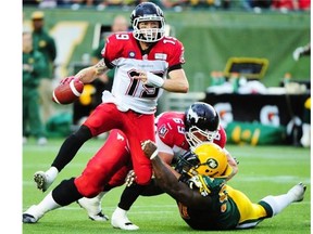 Calgary Stampeders quarterback Bo Levi Mitchell evades a tackle during Thursday’s Battle of Alberta.