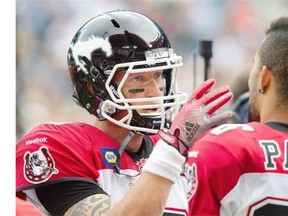Calgary Stampeders quarterback Bo Levi Mitchell talks to receiver Anthony Parker on the sidelines during the first half of their CFL game against the Toronto Argonauts in Toronto on Saturday.