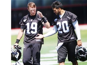 Calgary Stampeders quarterbacks Bo Levi Mitchell, left, and third-stringer Bryant Moniz celebrate a solid day of practice on Monday.