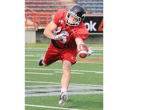 Calgary Stampeders running back Charlie Power reaches for a pass during practice at McMahon Stadium on Wednesday.