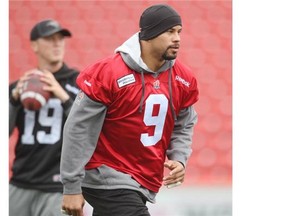 Calgary Stampeders running back Jon Cornish takes off in front of quarteback Bo Levi Mitchell during practice at McMahon Stadium on Wednesday.