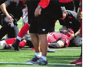 Calgary Stampeders running back Jon Cornish is tended to on the field after taking a clothesline hit from Montreal Alouettes linebacker Kyries Hebert at McMahon Stadium. The Stamps won the game 29-8, but Cornish has been out of action since the June 28 matchup.