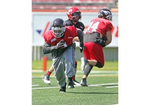 Calgary Stampeders running back Jock Sanders runs through drills with teammates during practice at McMahon Stadium on Tuesday. The Stamps are getting ready to host the Hamilton Tiger-Cats on Friday night.