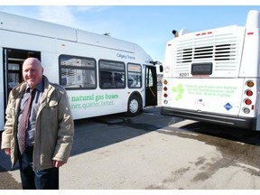 Calgary Transit spokesman Ron Collins with two natural gas buses that were used in a year-long trial to test their viability in local conditions.
