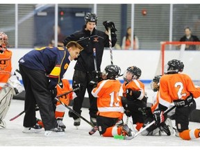Canada's Aaron Ekblad talks with a group of young skaters with the Snyder Youth Hockey Foundation at Scanlon Rink on Thursday, June 26, 2014, in Philadelphia as part of a clinic put on by six of the players expected to be picked in the first round of the upcoming NHL hockey draft. (AP Photo/The Philadelphia Inquirer, Clem Murray)