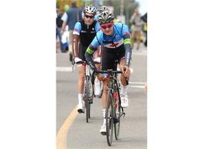 Canadian National Team member Adam de Vos, foreground, rides to the starting line for Stage 2 of the Tour of Alberta from Innisfail to Red Deer on Thursday.