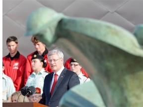 Canadian Prime Minister Stephen Harper takes part in bi-national ceremony of Rememberance marking the 70th anniversary of D-Day at Juno beach in Courseulles-sur-Mer, France, on Friday, June 6, 2014. THE CANADIAN PRESS/Adrian Wyld