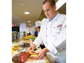 Chef Mike Dekker prepares a prime rib sandwich at the SAIT Culinary Campus.