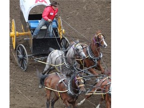 Children’s Wish Foundation chuckwagon driver Devin Mitsuing drove his team out of the start area during heat 4 of the Rangeland Derby at the Calgary Stampede on Sunday night.