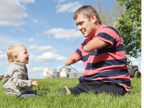 Chris Koch of Nanton shares a blade of grass with his nephew Brayden. Koch has become an Internet sensation after a short documentary film made by John Chester featuring him was broadcast on the Oprah Winfrey Show. He was born without arms or legs but has gone on to achieve many things, including his dream of being a farmer.