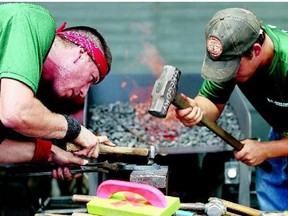 Chris Madrid of New Mexico and Cody Gregory of Lamar, Mo., put the finishing touches on a horseshoe in the first rounds of the blacksmiths' competition at the Calgary Stampede on Friday. This was the 35th anniversary for the event, which may not continue in its current form after this year.