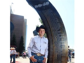 Chuckwagon champion Luke Tournier (2005) poses with the art instalment, “100 years of Champions,” which honours winners of the Calgary Stampede rodeo and chuckwagon races. The piece is in front of the Grandstand.