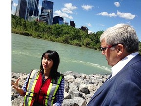 City engineer Lee Hang speaks with Premier Dave Hancock about flood mitigation during a flood remediation tour Tuesday.